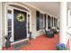 Welcoming front porch with comfortable seating, stylish decor, and a charming entrance, perfect for relaxing outdoors at 8661 Refuge Point Cir, North Charleston, SC 29420