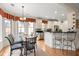 Bright eat-in kitchen featuring white cabinetry, granite countertops, stainless steel appliances, and a cozy breakfast nook at 8661 Refuge Point Cir, North Charleston, SC 29420