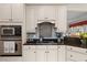 Bright kitchen features stainless steel appliances, gas cooktop, backsplash and granite countertops at 8661 Refuge Point Cir, North Charleston, SC 29420