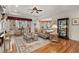 Sophisticated living room with hardwood floors, fireplace, elegant furnishings, and ample natural light, creating a cozy ambiance at 8661 Refuge Point Cir, North Charleston, SC 29420
