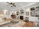 Inviting living room with hardwood floors, a fireplace, and custom built-ins, creating a warm and welcoming space at 8661 Refuge Point Cir, North Charleston, SC 29420