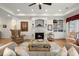 Inviting living room features hardwood floors, a fireplace, and custom built-ins, perfect for relaxing and entertaining guests at 8661 Refuge Point Cir, North Charleston, SC 29420