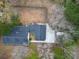 A property with a well-maintained roof, a beautiful backyard, and mature trees, as seen from above at 9030 Ethel Rd, North Charleston, SC 29406