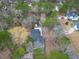 Aerial view showcasing a property nestled amongst trees, with long driveway and a well-maintained yard at 9030 Ethel Rd, North Charleston, SC 29406