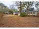 A large backyard with wood fence and mature trees, and access to the deck at 9030 Ethel Rd, North Charleston, SC 29406