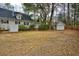 A large backyard with storage shed, and a home with a well-kept lawn and mature trees at 9030 Ethel Rd, North Charleston, SC 29406
