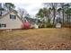 A large backyard with blooming shrubs, mature trees, a storage shed and a charming home at 9030 Ethel Rd, North Charleston, SC 29406