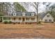 An inviting home with a large porch and a detached garage creating a welcoming atmosphere at 9030 Ethel Rd, North Charleston, SC 29406