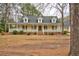 Charming home featuring a welcoming front porch, dormer windows, and well-maintained landscaping at 9030 Ethel Rd, North Charleston, SC 29406