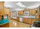 Bright kitchen features wood cabinets, a skylight, stainless steel appliances, and a double basin sink at 9030 Ethel Rd, North Charleston, SC 29406