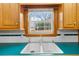 Close-up of the kitchen sink with a double basin, wood cabinets, and a window with a view at 9030 Ethel Rd, North Charleston, SC 29406