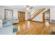 Spacious living room boasts hardwood floors, staircase, and a decorative front door at 9030 Ethel Rd, North Charleston, SC 29406