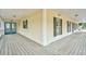 Spacious covered porch with a wooden floor and double-door entrance offers outdoor living space at 9030 Ethel Rd, North Charleston, SC 29406