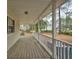 Expansive covered porch with white railing overlooks the landscaped backyard at 9030 Ethel Rd, North Charleston, SC 29406