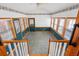 Bright sunroom featuring tile flooring, wainscoting, and large windows offering lots of natural light at 9030 Ethel Rd, North Charleston, SC 29406
