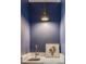 Modern half-bathroom with a vessel sink, stylish light fixture, and Grateful Dead art at 92 Bogard St, Charleston, SC 29403