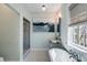 Bathroom featuring a clawfoot tub, glass-enclosed shower, and stylish fixtures at 92 Bogard St, Charleston, SC 29403