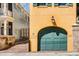 A garage with a large arched door sits adjacent to a brick walkway and two-story home at 92 Bogard St, Charleston, SC 29403