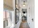 Bright hallway featuring natural light, hardwood floors, and stylish decor leading into the living room at 92 Bogard St, Charleston, SC 29403