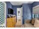 Living room featuring stylish furnishings, blue walls, and open door leading to a bathroom at 92 Bogard St, Charleston, SC 29403