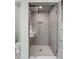 Bathroom featuring a glass-enclosed shower and white tiled walls and floor at 92 Bogard St, Charleston, SC 29403