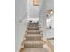 View of a carpeted staircase with a white railing, leading to the upper level of the home at 92 Bogard St, Charleston, SC 29403