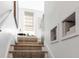 Charming stairway with carpet runner and built-in shelving unit at 92 Bogard St, Charleston, SC 29403