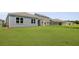 View of a green lawn that stretches behind a light-blue home with gray roof at 1036 Forrest Creek Dr, Summerville, SC 29483