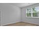 Bedroom featuring neutral paint, large window with blinds and vinyl wood-look flooring at 1036 Forrest Creek Dr, Summerville, SC 29483