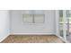 Spacious bedroom with wood floors, large window, and sliding door access to the backyard at 1036 Forrest Creek Dr, Summerville, SC 29483