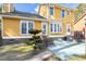 Charming two-story home features a well-maintained backyard with a patio, manicured lawn, and mature trees at 104 Broadmarsh Ct, North Charleston, SC 29418