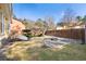 Landscaped backyard features a rock garden and stone fire pit, complemented by a lush lawn and mature trees at 104 Broadmarsh Ct, North Charleston, SC 29418