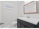 Stylish bathroom features a black vanity with modern fixtures and a framed mirror that reflects a tiled shower at 104 Broadmarsh Ct, North Charleston, SC 29418