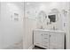 Modern bathroom features a glass-enclosed shower and double vanity with marble countertop and unique mirrors at 104 Broadmarsh Ct, North Charleston, SC 29418