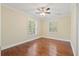 This bright, airy bedroom boasts hardwood floors, a ceiling fan and natural light from shuttered windows at 104 Broadmarsh Ct, North Charleston, SC 29418