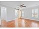Spacious bedroom features hardwood floors, a ceiling fan, and a stylish sliding barn door to the ensuite at 104 Broadmarsh Ct, North Charleston, SC 29418