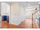 Inviting entryway featuring wood floors, wainscoting and views to kitchen, dining room and stairs at 104 Broadmarsh Ct, North Charleston, SC 29418