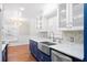 Bright kitchen with stainless steel appliances, quartz countertops, and farm sink with view to dining area at 104 Broadmarsh Ct, North Charleston, SC 29418
