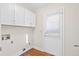Efficient laundry area with white cabinets, door to outside and wood flooring at 104 Broadmarsh Ct, North Charleston, SC 29418