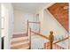 Bright hallway boasts hardwood stairs with white risers and classic wooden banisters, leading to the upper level at 104 Broadmarsh Ct, North Charleston, SC 29418