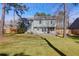 Exterior view of a light green two-story home with a spacious fenced-in backyard at 105 Thousand Oaks Cir, Goose Creek, SC 29445