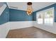 Formal dining room with elegant lighting, wainscoting, and laminate wood floors at 105 Thousand Oaks Cir, Goose Creek, SC 29445