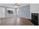 Open-concept living room with wood-look floors and a white trimmed fireplace at 105 Thousand Oaks Cir, Goose Creek, SC 29445