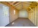Unfinished shed featuring a window and door, presenting an opportunity for customization at 105 Thousand Oaks Cir, Goose Creek, SC 29445