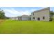 Green lawn with light gray vinyl siding and white trim on new construction home at 1054 Forrest Creek Dr, Summerville, SC 29483