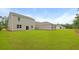 Large backyard featuring lush green lawn and light gray vinyl siding on the home at 1054 Forrest Creek Dr, Summerville, SC 29483