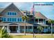 Attractive clubhouse with a symmetrical facade, manicured lawn, and stately palm trees at 1126 Ocean Forest Lane, 1/8 Share, Seabrook Island, SC 29455
