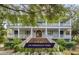 Grand home exterior boasting multi-level balconies, white columns, and meticulous landscaping, offering classic charm and curb appeal at 1126 Ocean Forest Lane, 1/8 Share, Seabrook Island, SC 29455