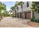 Large garage for up to three cars with a concrete driveway lined with mature trees and landscaping at 1126 Ocean Forest Lane, 1/8 Share, Seabrook Island, SC 29455