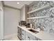 Stylish kitchenette with modern appliances, custom cabinets, and a mosaic backsplash, offering a functional space at 1126 Ocean Forest Lane, 1/8 Share, Seabrook Island, SC 29455